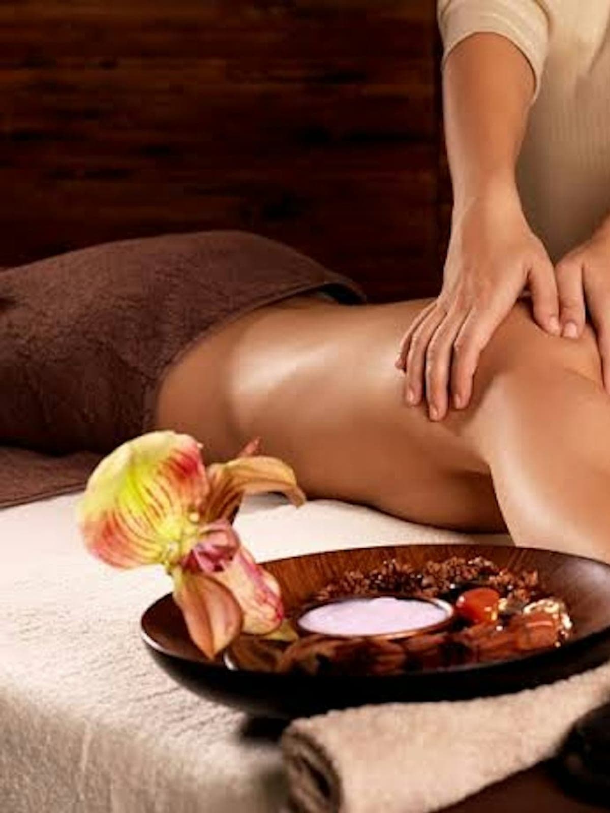 An in-villa spa massage with aromatherapy and an orchid.