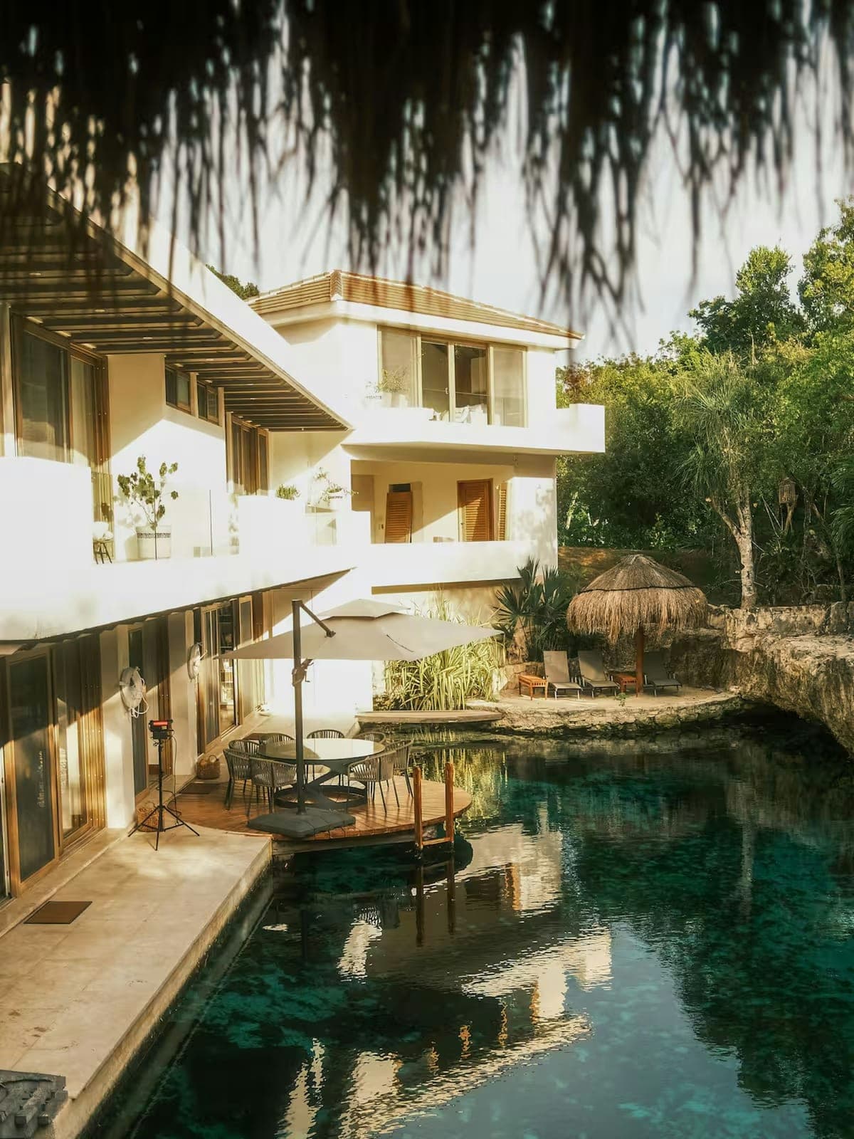 Casa Piedra de Agua, a stone villa in Puerto Aventuras, Riviera Maya: a pool set between stone walls and greenery.