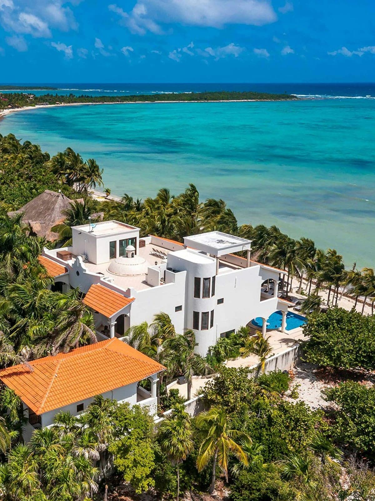 Hacienda Caracol, an oceanfront villa in Tulum, Riviera Maya: an aerial view of the white house beside the Caribbean.